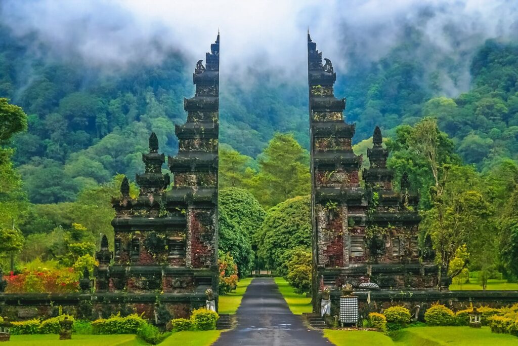 Traditional stone-carved entrance doors in Bali with intricate Balinese architecture.